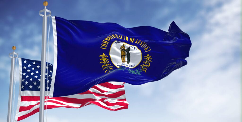The Kentucky state flag waving along with the  flag of the U.S.A. 