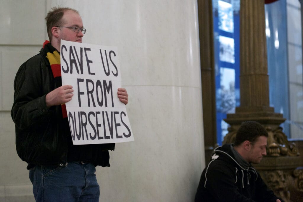 Harrisburg, PA, USA - December 19, 2016: A sole protestors stands inside the State Capitol rotunda in anticipation of members of the Electoral College. 