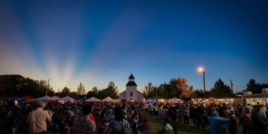 Clint, Texas, USA - August 6, 2022: The sun sets on the crowd at the San Lorenzo Church Fiesta near El Paso, Texas.