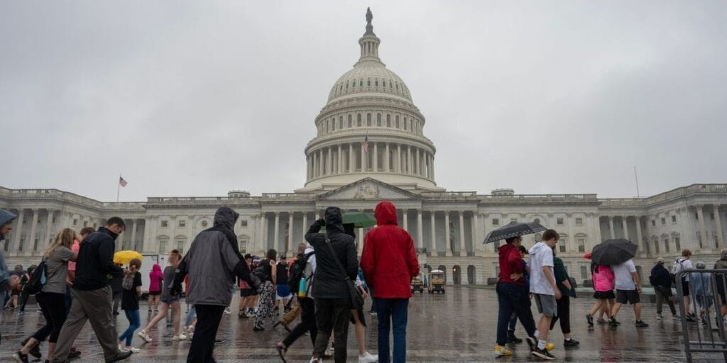 Washington, DC, USA - June 23, 2022: Groups of visitors at the East Front of the United States Capitol Building in Washington, DC, on a rainy day.