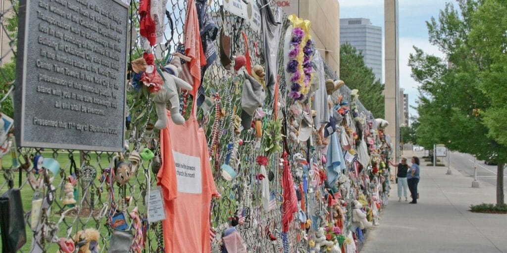 Oklahoma City, Oklahoma, USA - June 12, 2007: Two women look at all the items placed in memory of the fallen along the fence outside of the Oklahoma Bombing Memorial on June 12, 2007 in Oklahoma City, Oklahoma