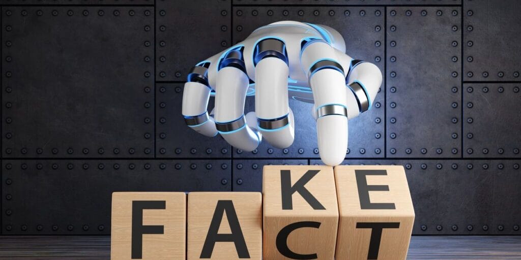 White robotic hand turning 2 wooden blocks revealing the words FACT and FAKE. 