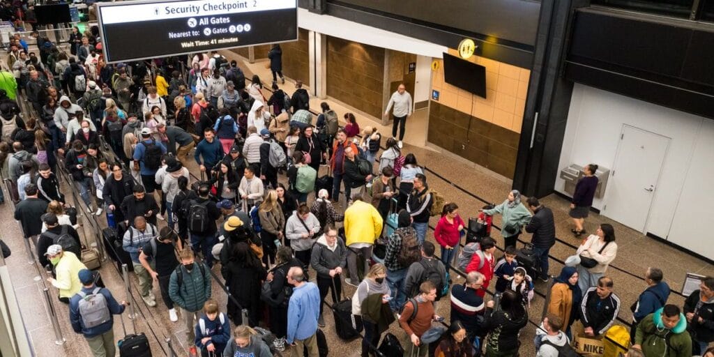 Seattle, USA - Apr 25 2023:  A crowded long line at a SeaTac airport security checkpoint late in the evening.