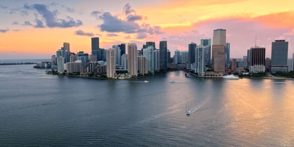 Aerial view of downtown Miami and Brickell Key island during sunset in Florida, USA.